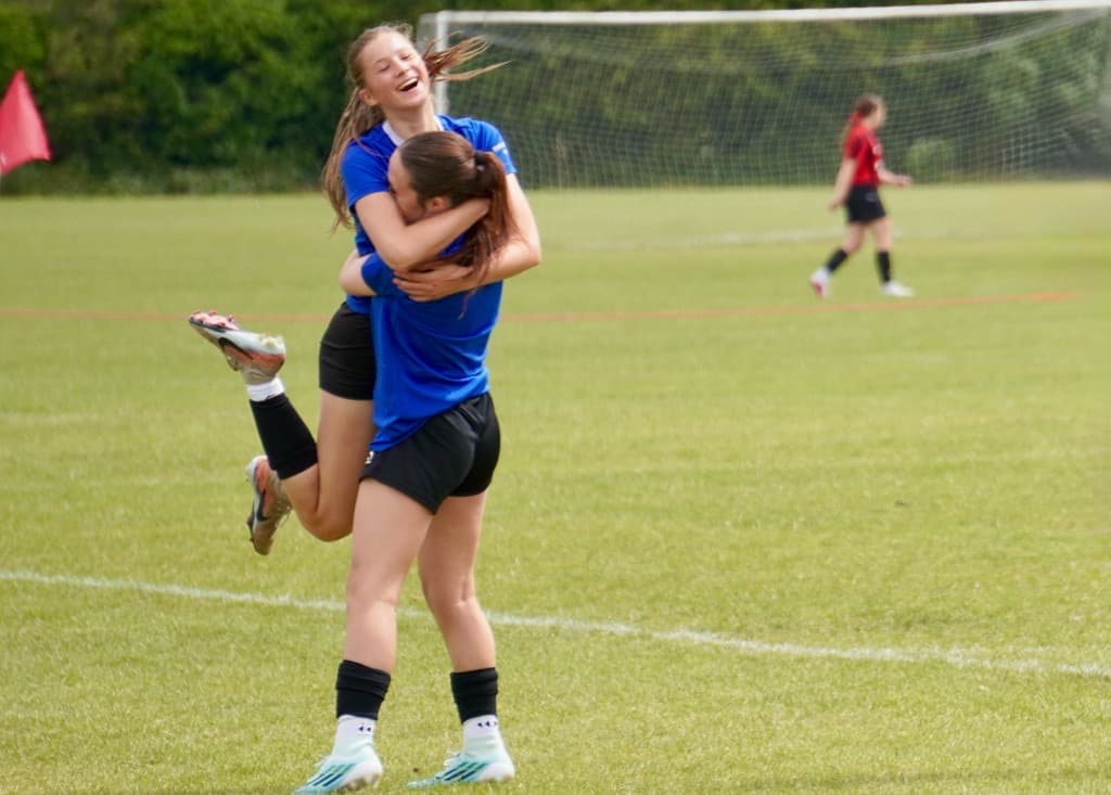 Teams celebrating together on the pitch at ACES Nationals 2026