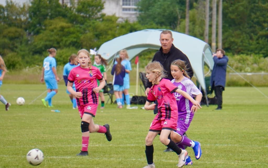 Excited supporters and players behind the touchline at ACES Nationals 2026