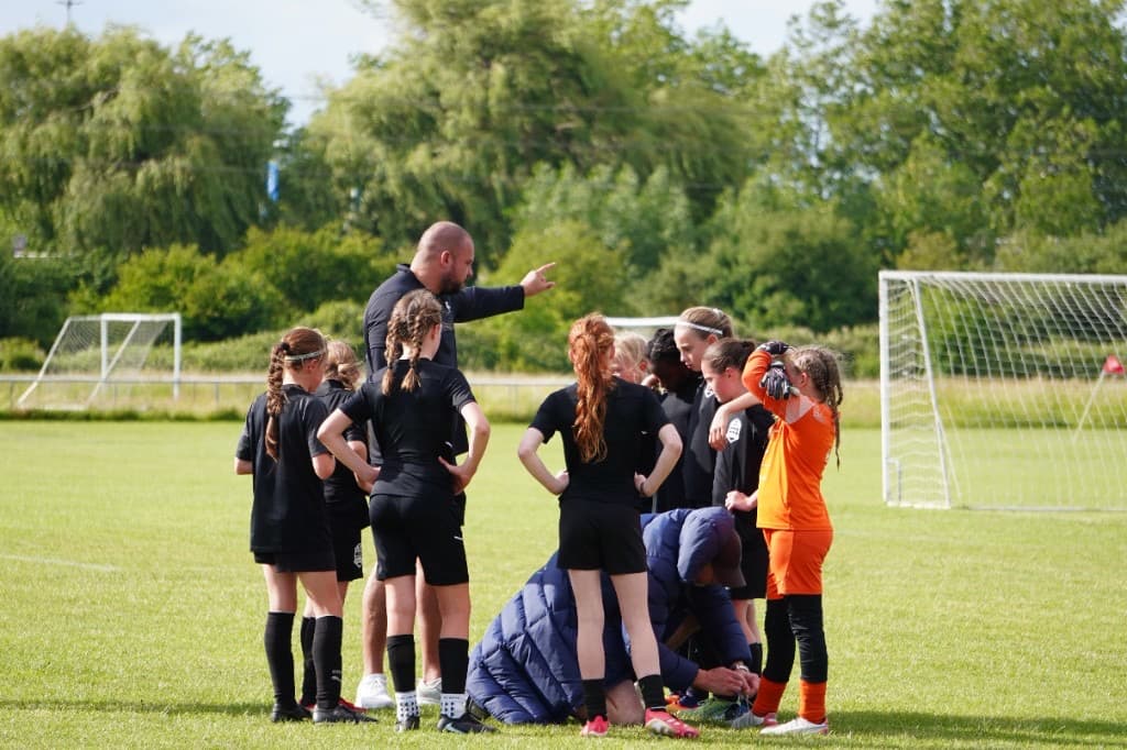 Girls' match action on the grass at ACES Nationals 2026